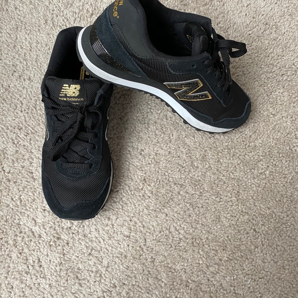 Black and gold New Balance women’s shoes